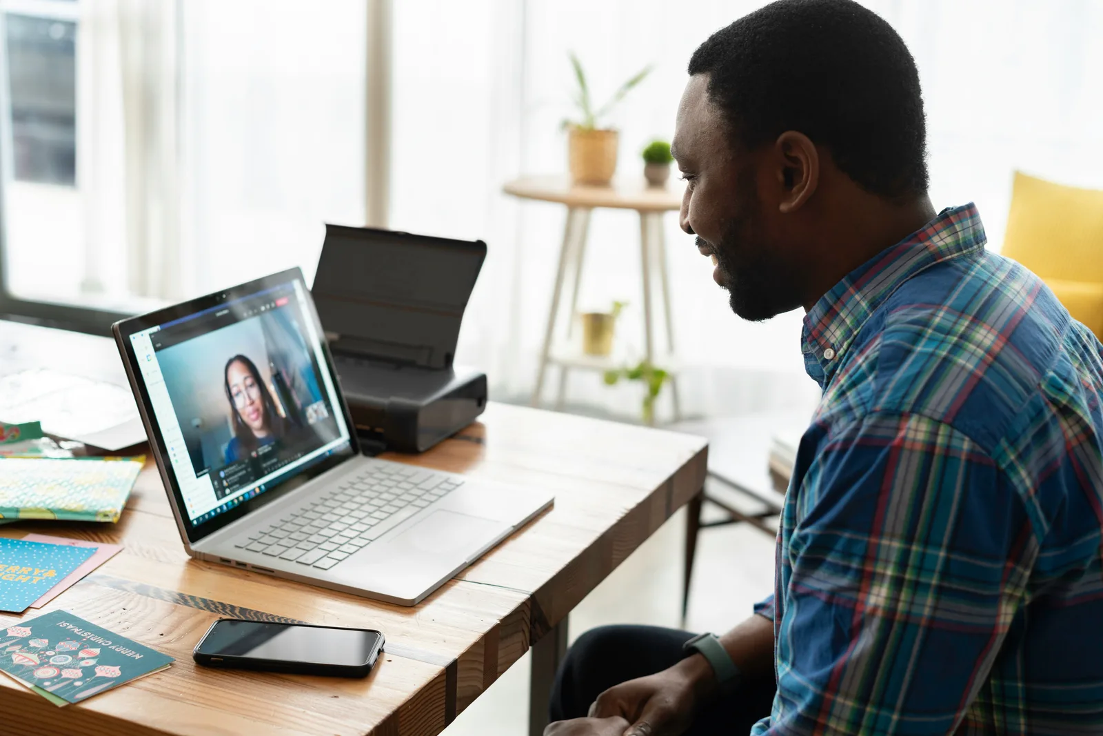 Man at home on a laptop video call, speaking with an attorney about his concerns rather than sitting in a traditional consultation at the lawyer's office.